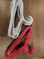 Pile of white and magenta plastic hangers