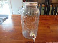 Full view of glass Mason jar dispenser with lid and spigot