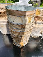 Stacked birch bark planters showing metal liners and bark texture
