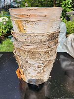 Stack of birch bark covered buckets exterior view