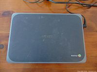 Closed ASUS Chromebook lid showing black and gray exterior with Chrome logo
