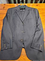 Full view of Banana Republic charcoal pinstripe suit jacket front