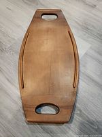 Top view of wooden tray showing handles, raised rails and finish