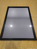 Front view of black framed mirror