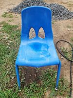 Front view of blue plastic child chair on ground