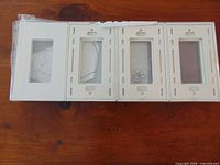 Front view of multiple gloss white screwless wall plates in packaging