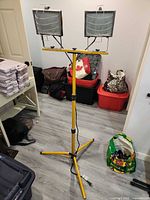 Full view of tripod work light front side showing two lamp heads and cord