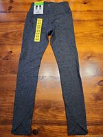Full view of leggings laid flat on surface