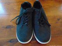 Top view of both sneakers showing laces, toe perforation, and condition