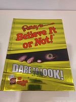 Front cover showing title, metallic finish and app mention
