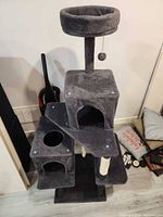 Full view of grey cat tree with top perch, platforms, condos, scratching posts