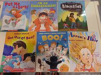 Six Robert Munsch paperback books arranged on table