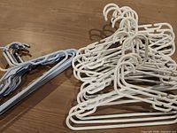 Group of white and blue plastic hangers on tabletop