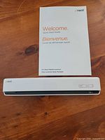 Scanner front view with quick start guide