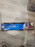 Retail box showing Athletic Works branding and image of curl bar