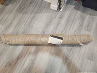 Rolled rug in packaging
