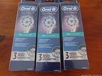 Front view of three sealed Oral-B Pro GumCare brush head packs