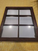 Front view showing 3x3 mirrored panes in dark wood frame
