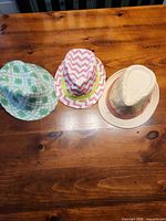 Top view of three fedoras showing colors and patterns