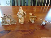 group view of four miniature metal desk clocks