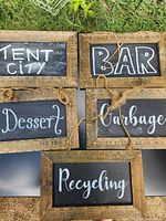 All five chalkboard signs laid out showing wording and frames
