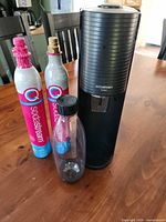 Soda maker front view with two CO2 cylinders and PET bottle