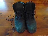 Top view of pair of black Timberland boots showing overall wear and scuffs