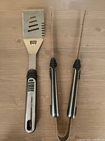 Spatula and tongs full view on tabletop