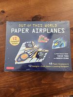 Front of sealed Tuttle Out of This World Paper Airplanes kit