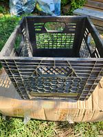 Overall view of black plastic Parmalat milk crate