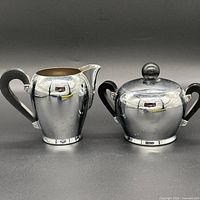 creamer and sugar bowl side by side front view