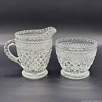 creamer and sugar bowl side by side