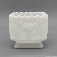 Front view showing grape relief and scalloped rim