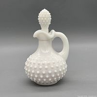 Front view of Avon hobnail milk glass cruet with stopper