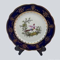 Front of porcelain plate showing pheasant motif, cobalt blue and gold rim