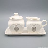 Full set showing sugar bowl, creamer and tray