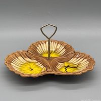 Top view of tri-lobed ceramic dish showing glaze colors and handle