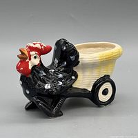 Left side profile of rooster planter showing cart and wheel