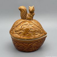Front angle of ceramic acorn jar with squirrel lid