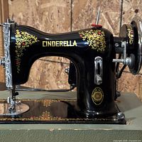 Left side view of Cinderella sewing machine showing decals, motor and drive wheel