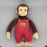 Front view of Curious George plush showing logo and overall condition