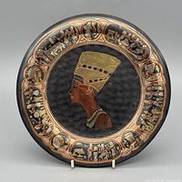 Front view of round copper-brass enamel plaque with Nefertiti portrait and Egyptian border