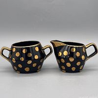 Creamer and sugar bowl front view showing pattern and size
