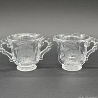 Full view of matching clear glass creamer and sugar bowl