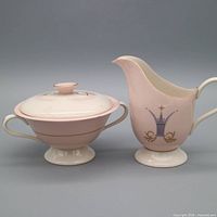 Front view of creamer and covered sugar bowl
