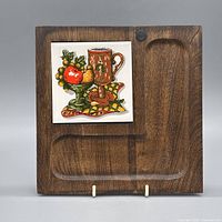 Front view showing full wood panel and inset ceramic tile graphic