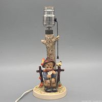 Full view lamp showing figure, column, socket, cord