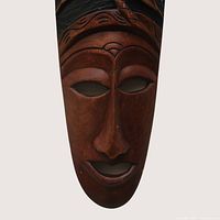 Full view of elongated carved wooden mask