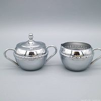 Creamer and lidded sugar bowl side-by-side front view