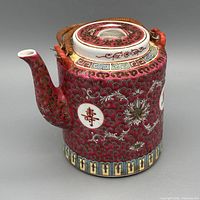 Front view showing spout, lid, and cane handle with longevity cartouche